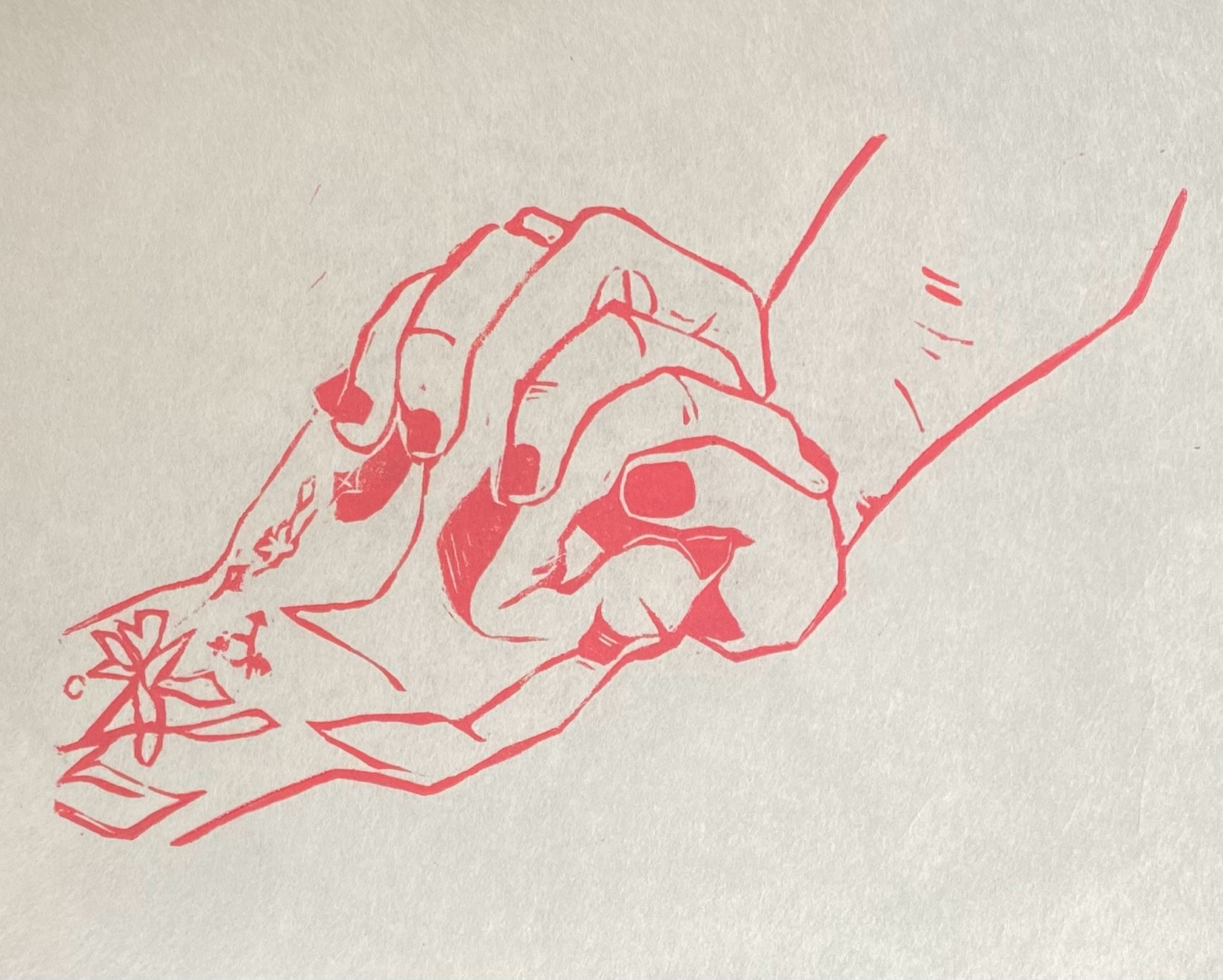 Linocut print on mulberry paper of two intertwined hands. Both sport nail polish, and one is covered in delicate tattoos (including a trans symbol).