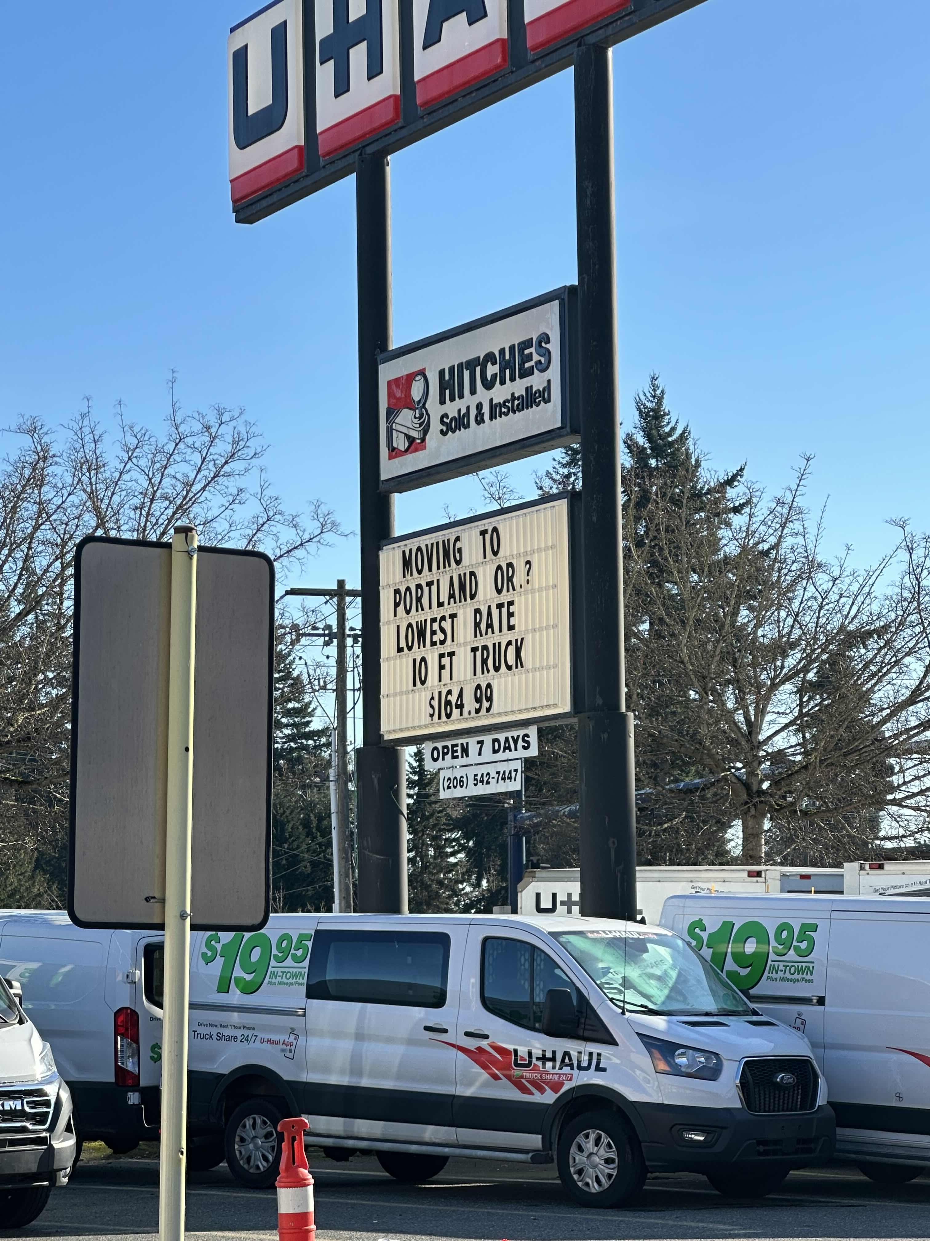 The sign of a U-Haul franchise. It reads 'MOVING TO PORTLAND OR? LOWEST RATE 10 FT TRUCK 164.99'